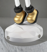 Detailed view of gold astronaut boots on sculpted base