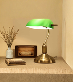 Banker desk lamp styled on table with books and decor