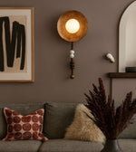 Modern artisan disc wall light in cozy contemporary living room