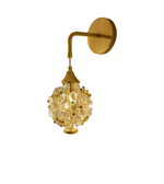 Luxury crystal flower wall sconce with brushed gold arm mounted on modern wall