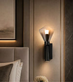 Modern smoked glass wall light beside luxury bed