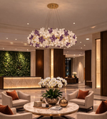 Luxury floral chandelier with white and purple flower design hanging in elegant hotel lobby interior
