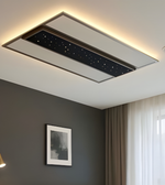 Ceiling-mounted air conditioning unit in a room with a gray wall and window.