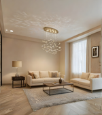 Modern living room with beige sofas, a coffee table, and decorative chandelier.