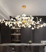 Modern chandelier with white floral design in a dining room setting.