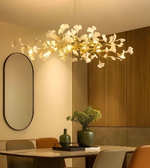 Modern chandelier in a dining room setting with a table and chairs.