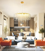 Modern living room with a chandelier, sofa, and chairs.