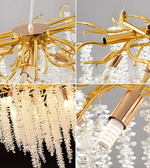 Gold and crystal chandelier with close-up details on a gray background