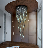 Modern chandelier hanging from a textured ceiling in a room with wooden flooring.