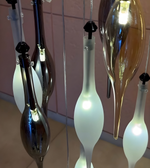 Decorative glass lights with a pink tiled wall background