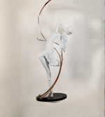 White abstract sculpture on a black base against a neutral background