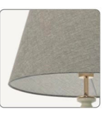 Textured lampshade with a gold fixture on a white background