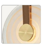 Decorative wall light fixture with gold finish and white background