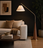 Modern living room with a beige sofa, floor lamp, and decorative items.