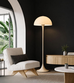 Modern living room with a floor lamp, armchair, and side table.