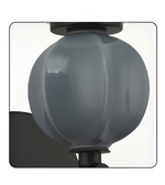 Detailed view of the sculptural blue-gray glass sphere accent mounted on a minimalist black fixture.