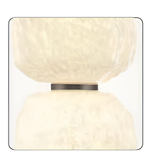 Modern wall light fixture with a textured white design on a white background