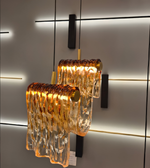 Modern pendant light with amber glass shades on a neutral background