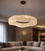 Luxurious chandelier hanging above a living room with a sofa and decorative items.