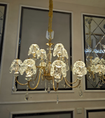 Crystal chandelier hanging in a room with mirrors on the wall.