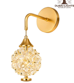 Gold wall-mounted lamp with crystal design on a white background, featuring the Dubai Lights logo.