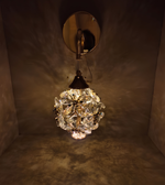 Wall-mounted light fixture with crystal ball design on a dark background