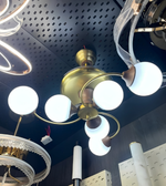 Ceiling light fixture with multiple white bulbs on a perforated ceiling