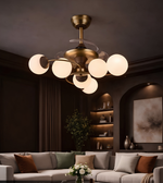 Modern chandelier in a living room setting with a sofa and decorative elements.