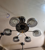 Modern chandelier with multiple light fixtures on a ceiling.