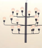 A modern multi-light chandelier with a matte black metal frame and multiple spherical frosted glass bulbs, shown against a plain off-white background.
