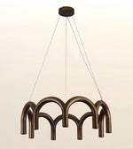 A modern multi-light linear chandelier with a bronze finish, featuring curved tubular arms suspended by thin cables from a round ceiling canopy, shown against a plain light background.