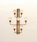 Modern brushed gold wall sconce featuring seven frosted globe lights mounted on a sleek cylindrical metal frame.
