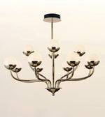 A modern 9-light chandelier with a polished silver-tone metal frame and textured white glass globes, suspended from a black ceiling canopy against a light beige background.