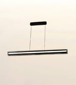 A modern linear LED ceiling light fixture suspended by two thin cables from a rectangular ceiling mount, shown against a plain off-white background.