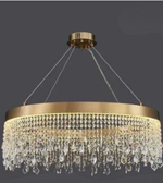 Gold chandelier with crystal accents on a dark background