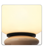 Decorative lamp with a beige shade and wooden base on a white background