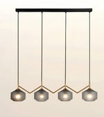 A modern 4-light linear pendant chandelier with textured gray glass shades, gold-tone metal accents, and black hanging rods against a light beige background.