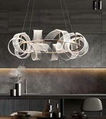 Modern dining room with dark wood table and chairs, marble backsplash, and decorative wall.