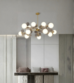 Modern chandelier hanging in a room with neutral decor