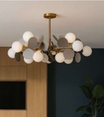 Modern chandelier with spherical lights in a room setting