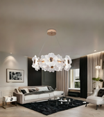 Modern living room with a decorative chandelier, sofa, and coffee table.