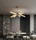 Modern chandelier in a dining room setting with a neutral color palette.