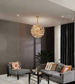 Modern living room with a chandelier, sofa, and armchair.