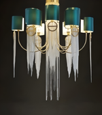Decorative chandelier with teal lampshades and icicle-style hanging elements on a dark background