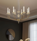 Chandelier hanging in a room with dark walls and a window.