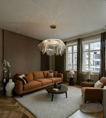 Modern living room with a brown sofa, coffee table, and decorative lamp.
