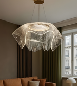Modern pendant light fixture in a living room setting with a window in the background.