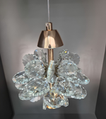 Crystal chandelier with gold fixture on a gray background
