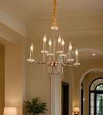 Chandelier hanging in a room with neutral walls and a window.