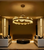 Modern living room with a stylish chandelier, white sofa, and decorative pillows.